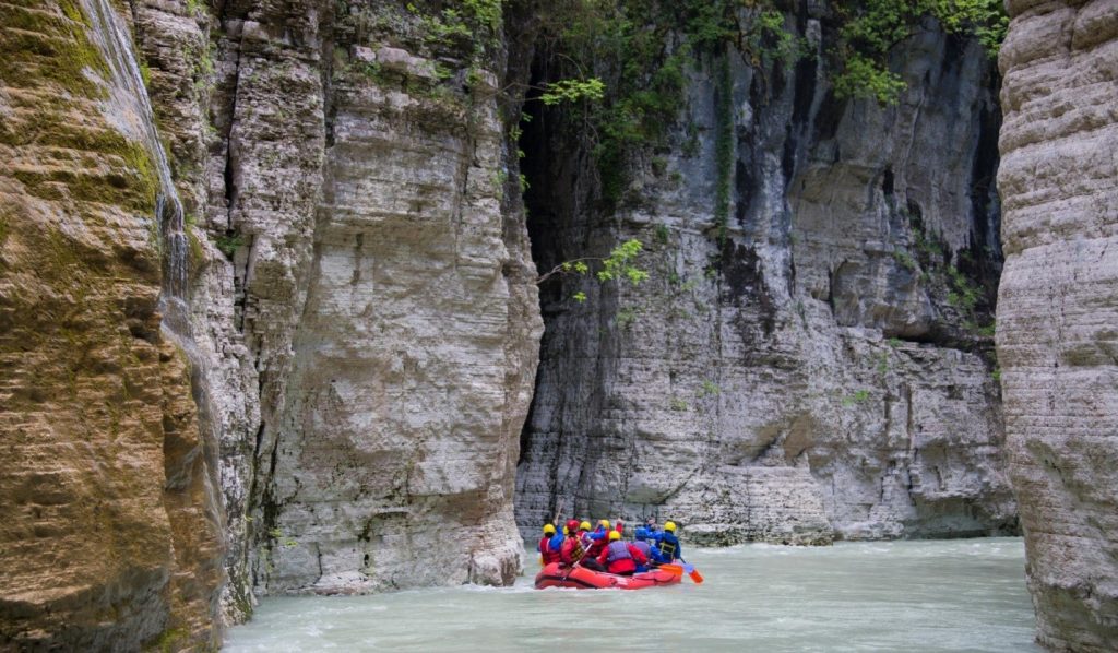 Tourists rafting through the narrow river passages of Osumi Canyon in southern Albania